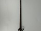 an old sword hanging on the wall in a room