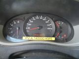 a speedometer on the dashboard of a car with a yellow sticker on it