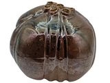 a brown vase with a flower decoration on it
