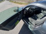 a car with its door open sitting on the side of the road