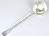 a silver spoon with a spoon handle on a white surface