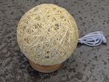 a ball of yarn sitting on top of a wooden stand