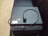 a laptop computer sitting on top of a desk with a power cord
