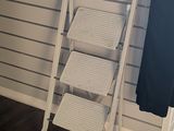a ladder that is leaning against a wall next to a window