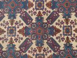 an oriental rug with a blue, red, and yellow design