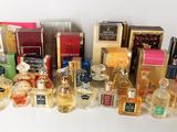 a lot of perfume bottles that are sitting on a table