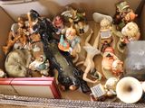 many figurines in a box on a table