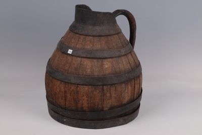 an old wooden barrel shaped jug with a handle on a gray background