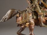 bronze statue of a man riding a horse with a sword in his hand