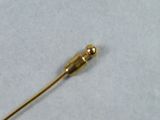 a gold colored pin on a white table cloth