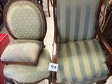 pair of antique chairs with upholstered cushions in a store