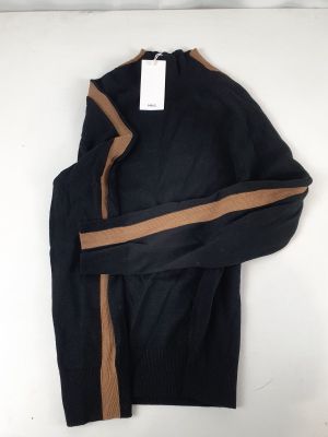 a black sweater with a brown stripe is hanging on a white wall