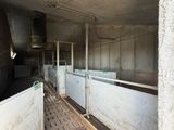 several stalls in a building that are empty of people