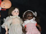 three dolls that are sitting next to each other on a table
