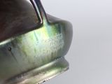 a close up of a vase with a handle on it