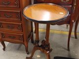 a small table with a mirror on top of it next to a chest of drawers