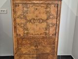 a wooden cabinet with a marble top in a bathroom