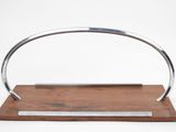 an image of a metal and wood handle on a wooden stand