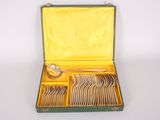 a green case with silverware in it on a white surface