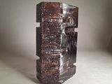 a sculpture of a man sitting on top of a stack of books