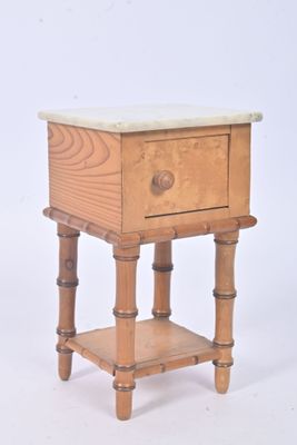 a small wooden table with a marble top on it