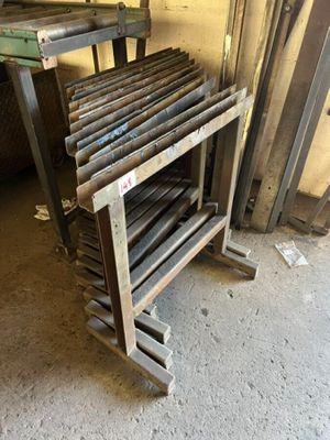 a pile of metal rods sitting on top of a wooden rack