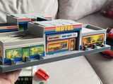 a person holding a toy train set in their hand