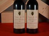 two bottles of wine sitting next to each other on a table