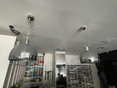 two lights that are hanging from the ceiling in the room