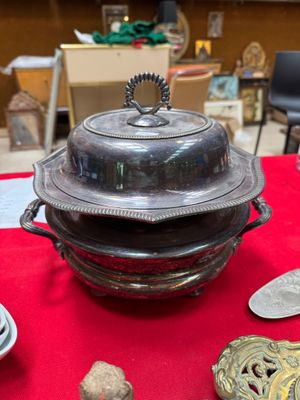 a red table cloth with silver objects on it