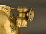 a gold statue of a horse with a bell on it ' s head