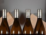 three bottles of wine sitting in a wooden box