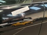 a sticker on the door of a car that is parked in a parking lot