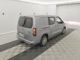 a grey van parked in a garage with a checkered floor