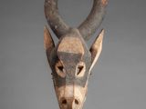a close up of a sculpture of a cow ' s head on a stand