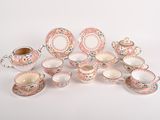 a group of porcelain dishes and cups on a white surface