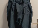 a blue pants hanging on a hanger on a door