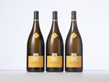 three bottles of wine sitting on top of a table next to each other