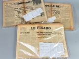 trois journaux sont emballés dans du plastique et posés sur une table