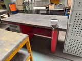 a workbench in the middle of a workshop with a lot of tools