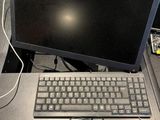 a desk with a keyboard and a monitor on it