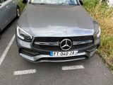 two cars parked in a parking lot next to each other