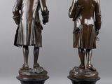 two bronze statues of a man and a woman standing next to each other