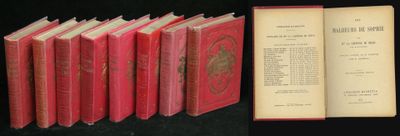 several books are lined up in a row on a black surface