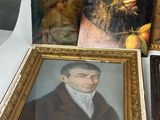 a lot of paintings on display on a table