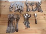 a lot of spoons and spoon knives on the table