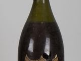 a bottle of champagne sitting on a table next to a bottle of wine