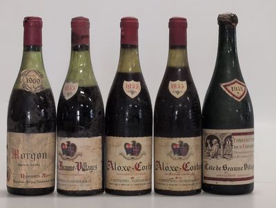 six bottles of wine are lined up on a table