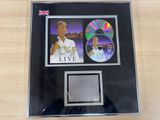 framed photograph of a man holding a tennis racquet in front of a cd