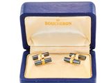 une paire de boutons de manchette dans un coffret bleu sur fond blanc